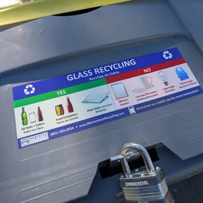 A garbage can with a label helping people know what they can and cannot recycle. 