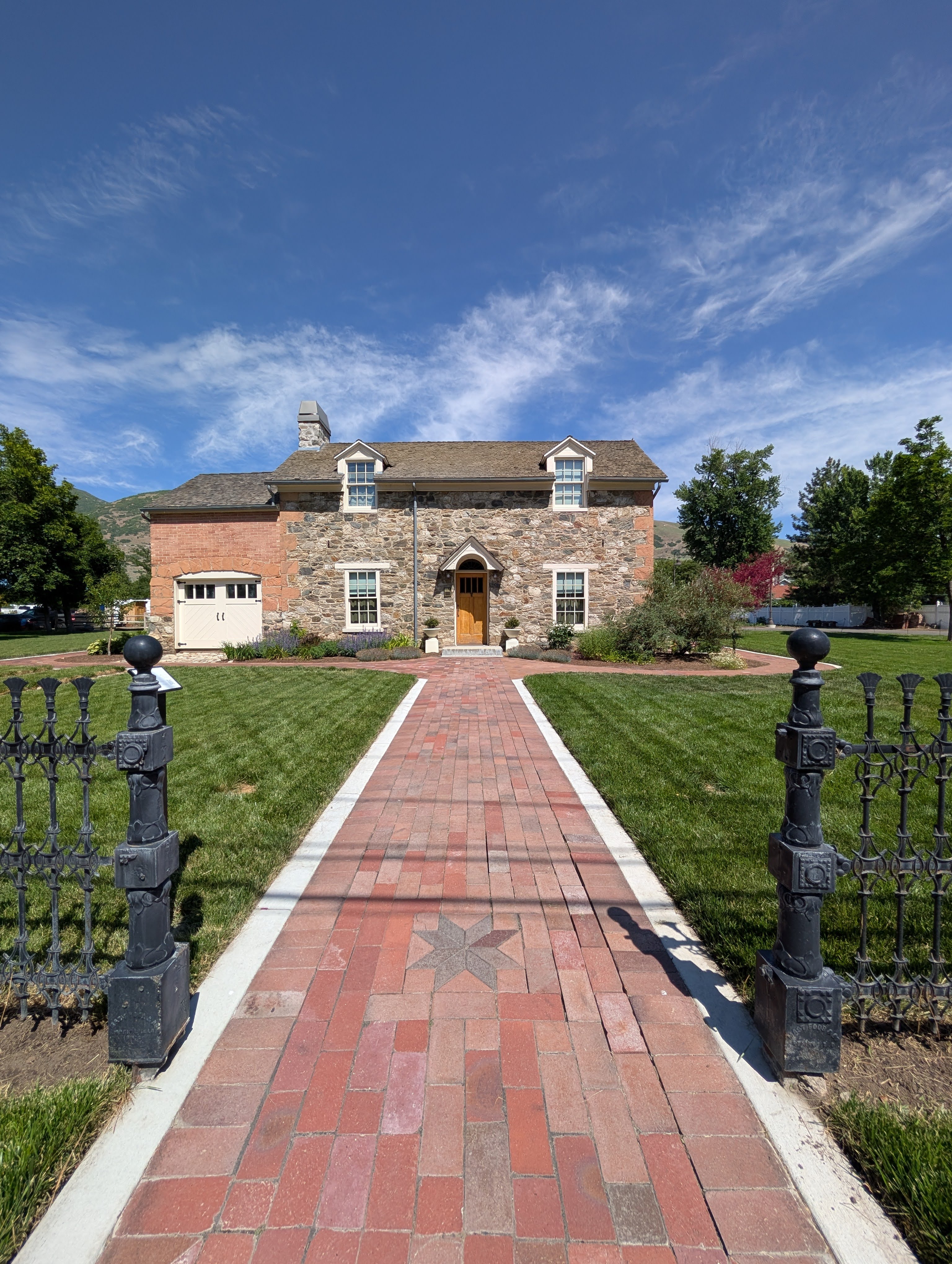 Rock clad front of the historic Whitaker home on a bright sunny summer afternon that is now the home to the Whitaker Museum