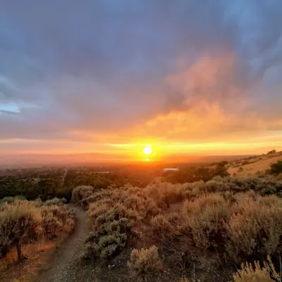 a walking path that leads to a sunset on top of a mountain in Centerville Utah