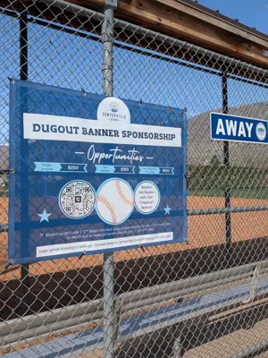 Become a dugout sponor banner hanging on the back of a dugout with cost breakdowns
