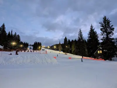 Ski resort groomed under at twilight under the lights